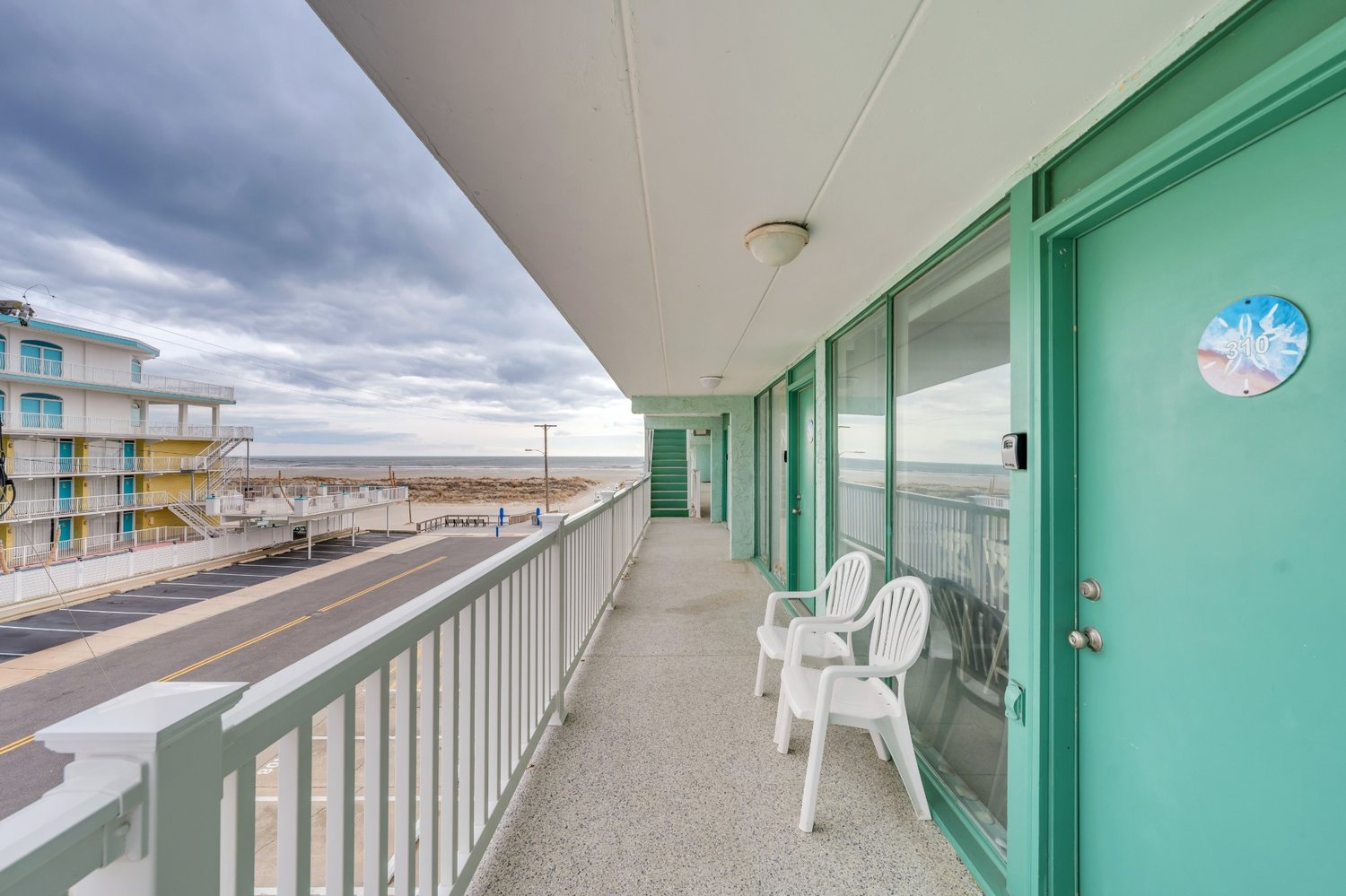 Third-floor walkway outside Unit 310 with an ocean view